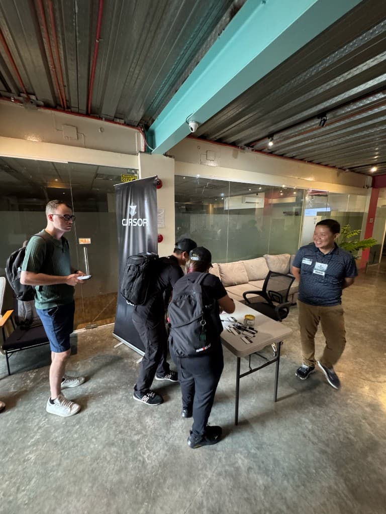 Registration area with Cursor banner and attendees